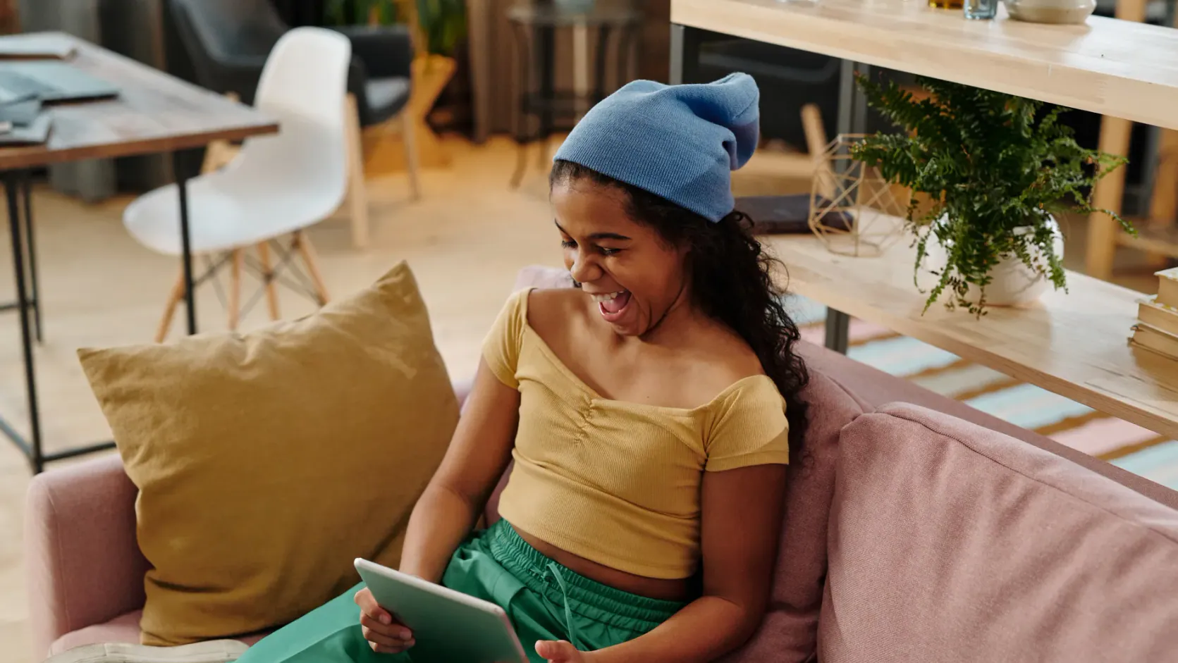 Computers Prices: 5 Affordable Options That Still Last 5 A person holding a tablet with a happy expression showing satisfaction with computers prices
