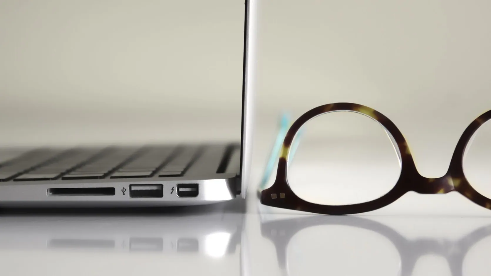 A photo of a laptop and desktop computer side by side, showing the difference in size and design, highlighting laptops vs desktops